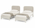 Conjunto de camas individuales de madera con cabeceras tapizadas en Beige